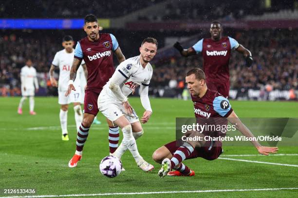 Emerson of West Ham, James Maddison of Tottenham Hotspur and Tomas Soucek of West Ham watch the ball bounce out of play during the Premier League...