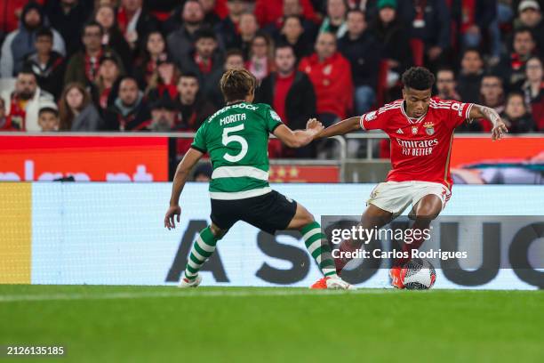 David Neres of SL Benfica tries to escape Hidemasa Morita of Sporting CP during the match between SL Benfica and Sporting CP for Semi-Final second...