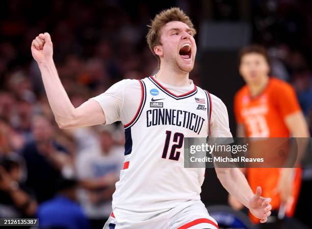 Cam Spencer of the Connecticut Huskies celebrates a basket against the Illinois Fighting Illini during the second half in the Elite 8 round of the...