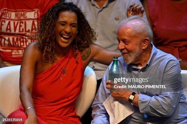 Brazilian Minister of Racial Equality Anielle Franco and President Luiz Inacio Lula da Silva share a light moment during an event to announce her...