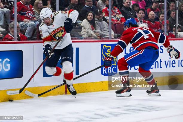 Florida Panthers center Evan Rodrigues plays the puck against Montreal Canadiens right wing Josh Anderson during the Florida Panthers versus the...