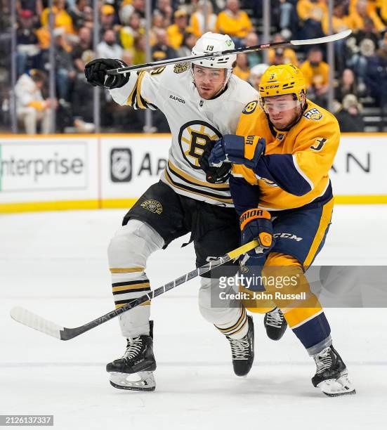 Pavel Zacha of the Boston Bruins skates against Jeremy Lauzon of the Nashville Predators during an NHL game at Bridgestone Arena on April 2, 2024 in...