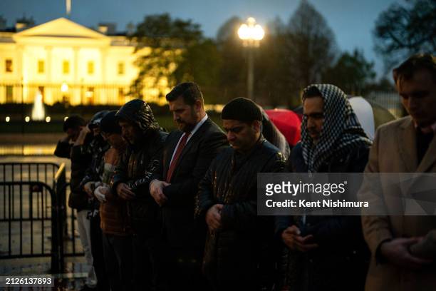 Pro-Palestinian demonstrators pray as they gather near the White House to call for a ceasefire in Gaza during a protest as part of the "People's...