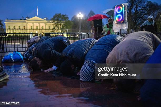 Pro-Palestinian demonstrators pray as they gather near the White House to call for a ceasefire in Gaza during a protest as part of the "People's...