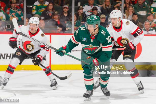 Vinni Lettieri of the Minnesota Wild scores a goal with Drake Batherson and Erik Brannstrom of the Ottawa Senators defending during the game at the...