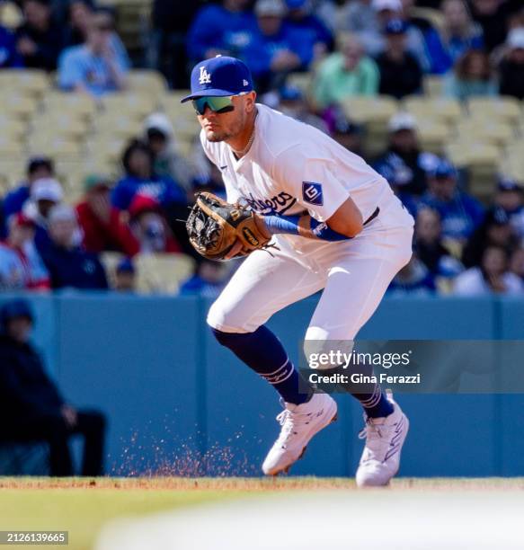 Los Angeles Dodgers shortstop Miguel Rojas fields the ball against the St Louis Cardinals on March 31, 2024 at Dodger Stadium in Los Angeles,...