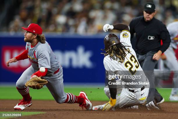 Fernando Tatis Jr. #23 of the San Diego Padres steals second base as Brendan Donovan of the St. Louis Cardinals fumbles the ball during a game at...