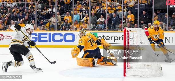 Pavel Zacha of the Boston Bruins scores a goal against Juuse Saros of the Nashville Predators during an NHL game at Bridgestone Arena on April 2,...