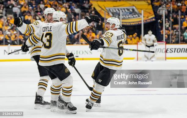 Charlie Coyle celebrates his goal with Brad Marchand and Brandon Carlo of the Boston Bruins against the Nashville Predators during an NHL game at...