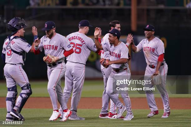 The Boston Red Sox celebrate beating the Oakland Athletics in extra innings at Oakland Coliseum on April 02, 2024 in Oakland, California.