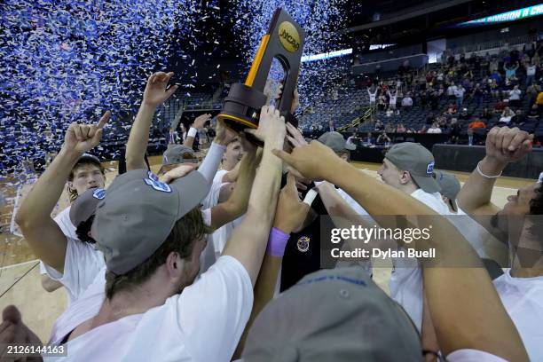 The Minnesota State Mavericks celebrate with the trophy after beating the Nova Southeastern Sharks 88-85 during the NCAA Division II Men's Basketball...