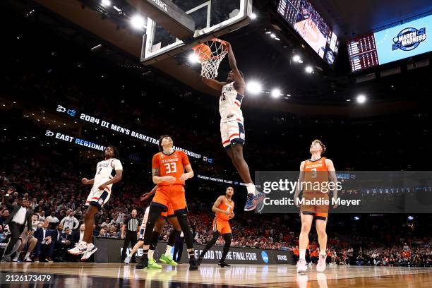 Samson Johnson of the Connecticut Huskies dunks the ball against the Illinois Fighting Illini during the second half in the Elite 8 round of the NCAA...