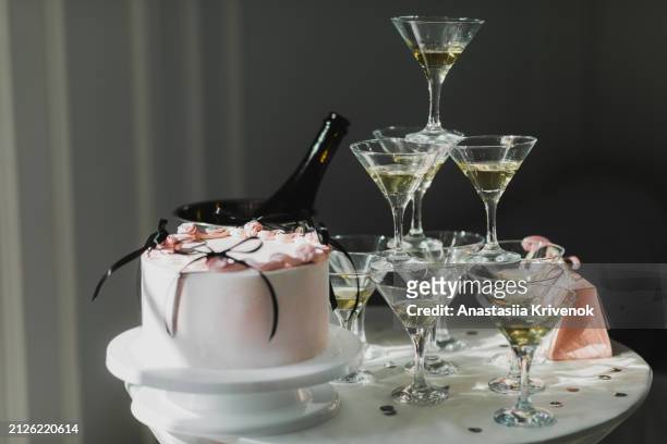 tower made of glasses with champagne on table. - champagne pyramid stockfoto's en -beelden