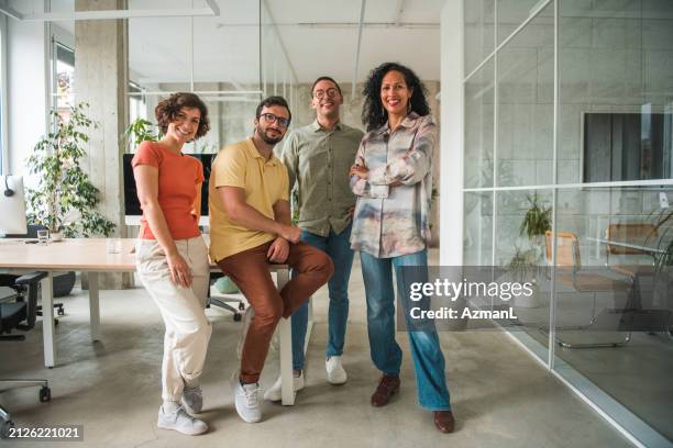 multicultural call center team showcases confidence with crossed hands in a modern office - customer retention stock pictures, royalty-free photos & images