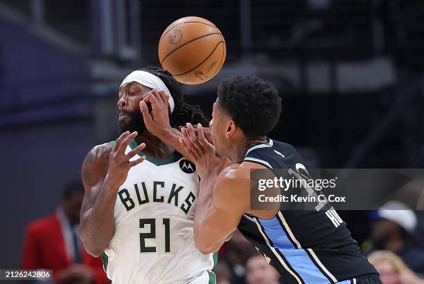 Patrick Beverley of the Milwaukee Bucks draws a foul as he takes a hand to the face from De'Andre Hunter of the Atlanta Hawks after a stealduring the...