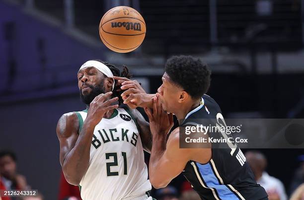 Patrick Beverley of the Milwaukee Bucks draws a foul as he takes a hand to the face from De'Andre Hunter of the Atlanta Hawks after a steal during...