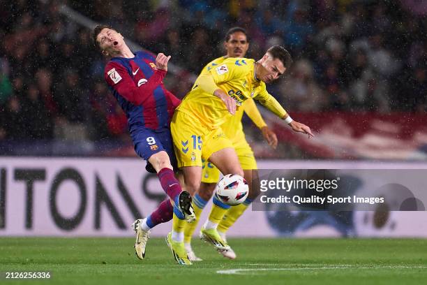 Robert Lewandowski of FC Barcelona competes for the ball with Mika Marmol of UD Las Palmas during the LaLiga EA Sports match between FC Barcelona and...