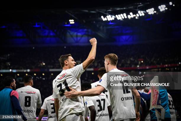 Lyon's Serbian defender Nemanja Matic and Lyon's Irish defender Jake O'Brien celebrate at the end of the French Cup semi final match between...