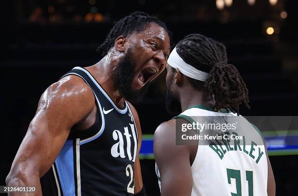 Bruno Fernando of the Atlanta Hawks reacts towards Patrick Beverley after drawing a foul on a basket against Khris Middleton of the Milwaukee Bucks...