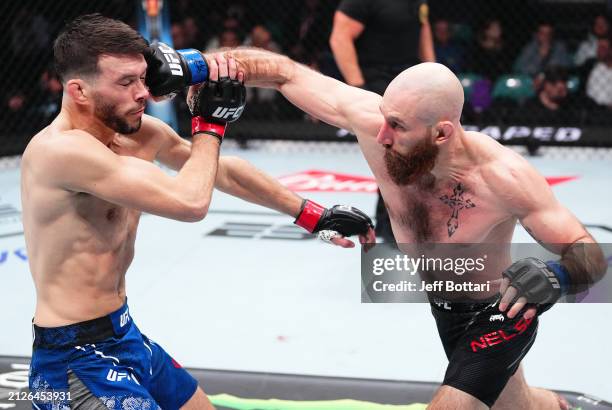 Kyle Nelson of Canada punches Bill Algeo in a featherweight bout during the UFC Fight Night event at Boardwalk Hall Arena on March 30, 2024 in...