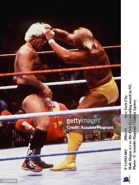 29Dec91 - New York City Hulk Hogan pulls the hair of Ric Flair during a wrestling match, New York City, New York, December 1991.