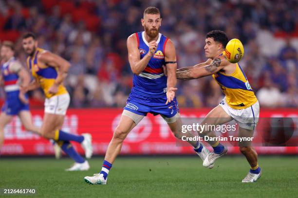 Liam Jones of the Bulldogs handballs during the round three AFL match between Western Bulldogs and West Coast Eagles at Marvel Stadium, on March 31...