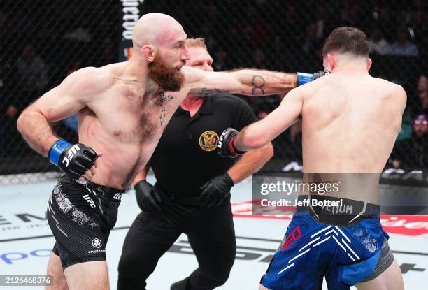 Kyle Nelson of Canada punches Bill Algeo in a featherweight bout during the UFC Fight Night event at Boardwalk Hall Arena on March 30, 2024 in...