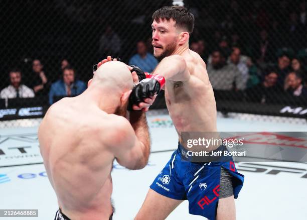 Bill Algeo punches Kyle Nelson of Canada in a featherweight bout during the UFC Fight Night event at Boardwalk Hall Arena on March 30, 2024 in...