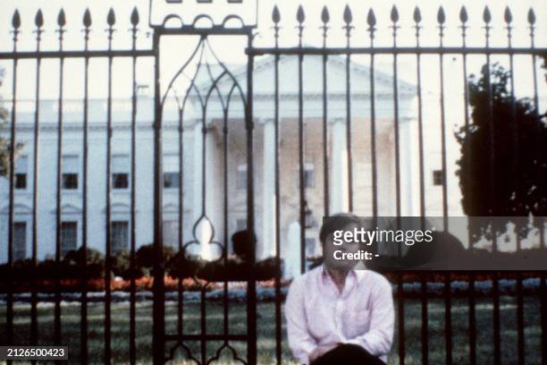 Picture taken in front of the White House of John Hinckley who attempted to assassinate US President Ronald Reagan in Washington, D.C., on March 30...