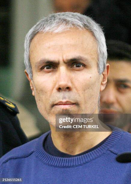 File photo dated 12 January 2006 shows Mehmet Ali Agca , would-be assassin of Pope John Paul II in 1981, accompanied by police during his release...