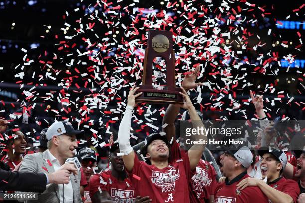 Mark Sears of the Alabama Crimson Tide celebrates with the trophy after defeating the Clemson Tigers 89-82 in the Elite 8 round of the NCAA Men's...