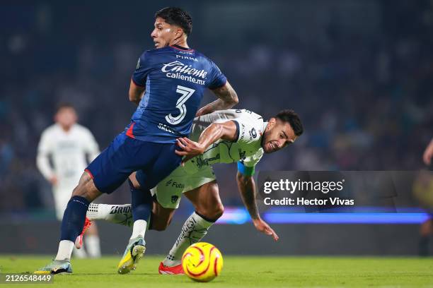 Carlos Salcedo of Cruz Azul battles for possession with Eduardo Salvio of Pumas UNAM during the 13th round match between Pumas UNAM and Cruz Azul as...