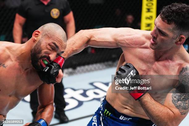 Chris Weidman punches Bruno Silva of Brazil in a middleweight bout during the UFC Fight Night event at Boardwalk Hall Arena on March 30, 2024 in...