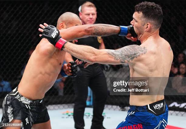 Bruno Silva of Brazil punches Chris Weidman in a middleweight bout during the UFC Fight Night event at Boardwalk Hall Arena on March 30, 2024 in...