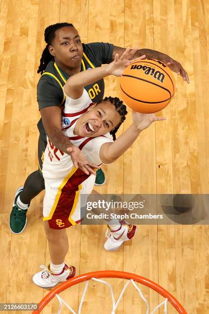 Dre'Una Edwards of the Baylor Lady Bears and McKenzie Forbes of the USC Trojans reach for a rebound in the Sweet 16 round of the NCAA Women's...