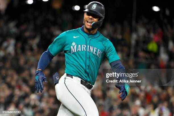 Julio Rodriguez of the Seattle Mariners reacts to hitting a walk-off single to win the game during the tenth inning against the Boston Red Sox at...