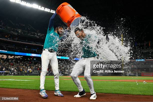 Crawford of the Seattle Mariners gives Julio Rodriguez a water shower after his walk-off single to win the game against the Boston Red Sox at...