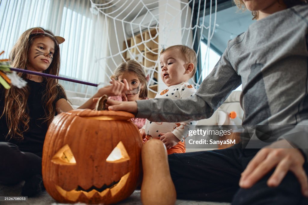 A group of children playing hocus pocus on a Halloween day