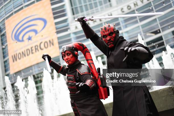 Cosplayers Mrs. & Mr. Capuchino dressed as Darth Talon and Darth Maul pose during 2024 WonderCon at Anaheim Convention Center on March 30, 2024 in...