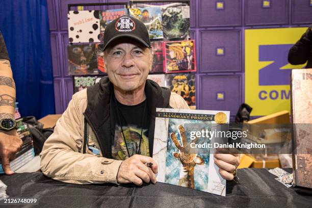 Singer Bruce Dickinson of Iron Maiden poses at a signing for his new graphic novel "The Mandrake Project" at Z2 Comics booth during 2024 WonderCon at...