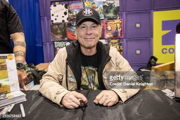 Singer Bruce Dickinson of Iron Maiden poses at a signing for his new graphic novel "The Mandrake Project" at Z2 Comics booth during 2024 WonderCon at...