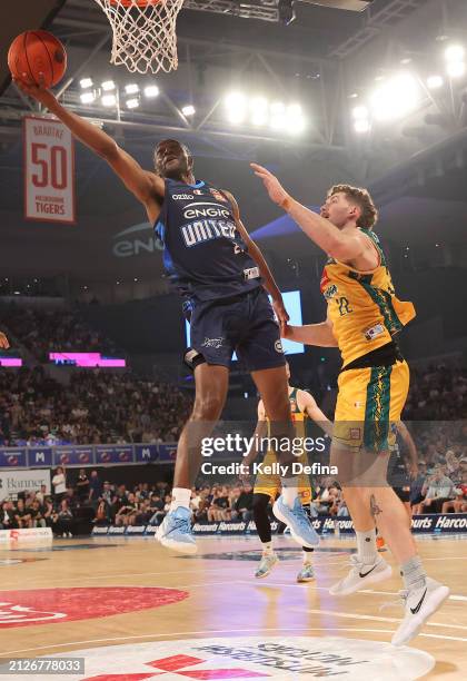 Ian Clark of United drives to the basket against Will Magnay of the JackJumpers during game five of the NBL Championship Grand Final Series between...