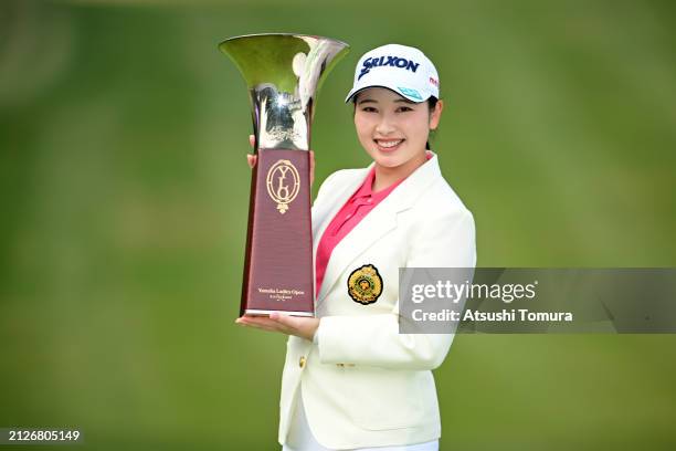 Sakura Koiwai of Japan poses with the trophy after winning the tournament following the final round of YAMAHA Ladies Open Katsuragi at Katsuragi Golf...