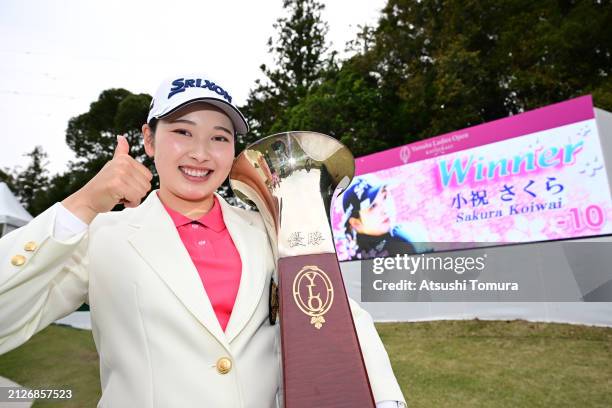 Sakura Koiwai of Japan poses with the trophy after winning the tournament following the final round of YAMAHA Ladies Open Katsuragi at Katsuragi Golf...