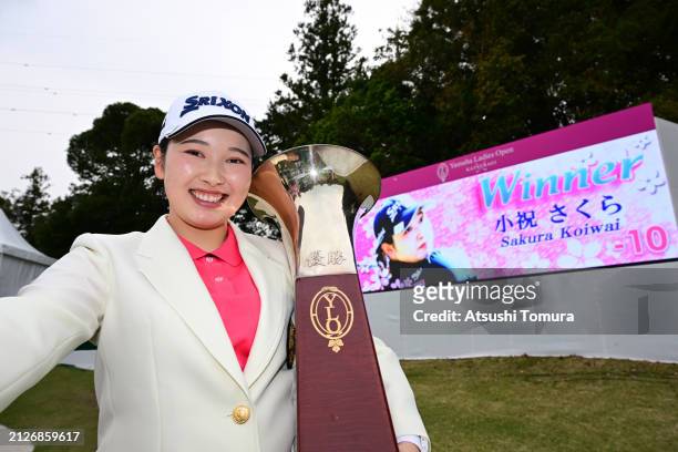 Sakura Koiwai of Japan imitates the selfie after winning the tournament following the final round of YAMAHA Ladies Open Katsuragi at Katsuragi Golf...