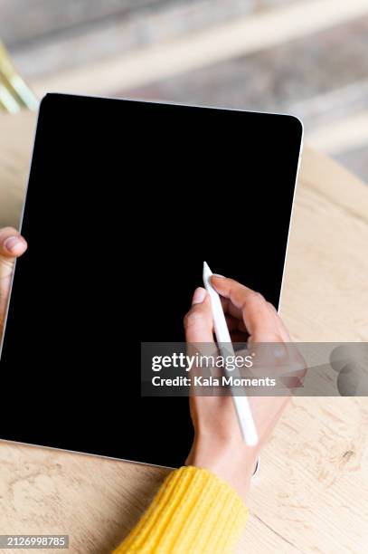close-up of a woman using graphics tablet and stylus - digitized pen stock pictures, royalty-free photos & images