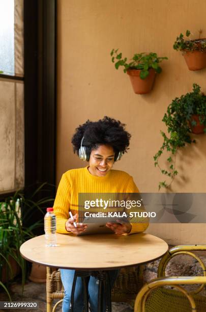 african smiling female designer using graphics tablet and stylus - graphic design studio stock pictures, royalty-free photos & images