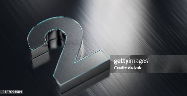 metallic number two on reflective stainless steel background - numerology stock pictures, royalty-free photos & images