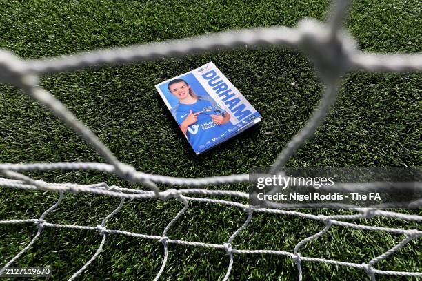 Detailed view of a matchday programme, through the nets of the goal, prior to the Barclays Women's Championship match between Durham and Crystal...