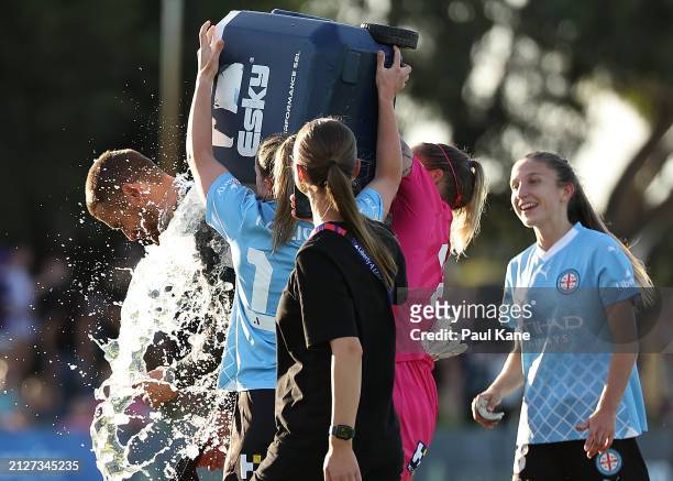 Rhianna Pollicina and Melissa Barbieri of Melbourne City tip an esky of icy water over Dario Vidosic, head coach of Melbourne City after winning the...